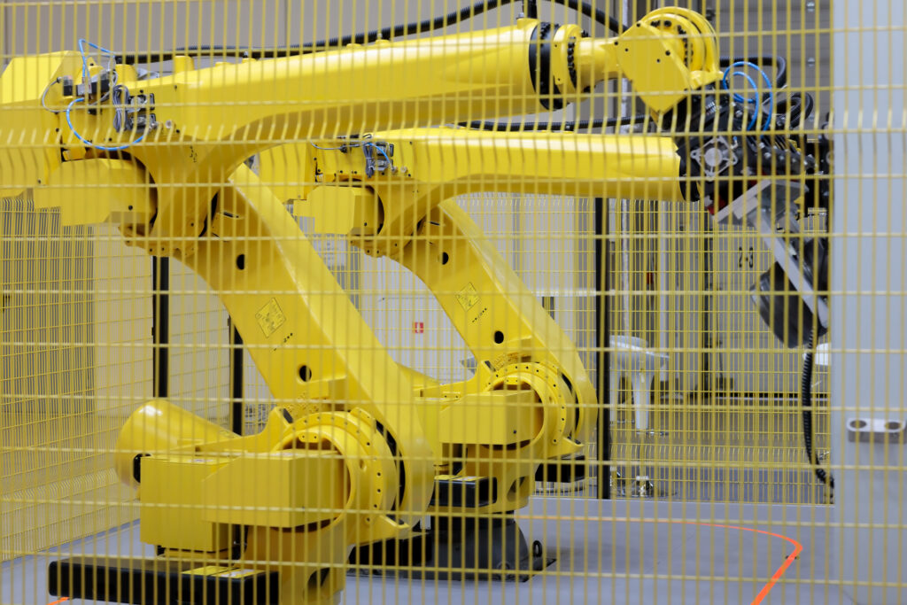 A mesh guard blocking in two collaborative robots