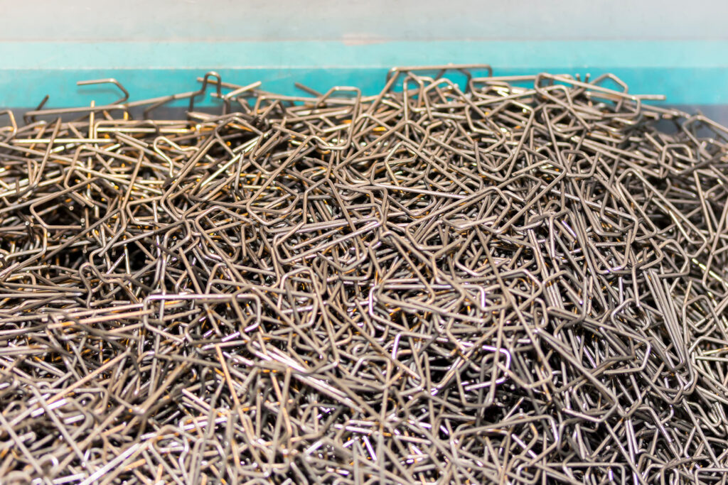 A pile of wire forms, bent into C shapes.